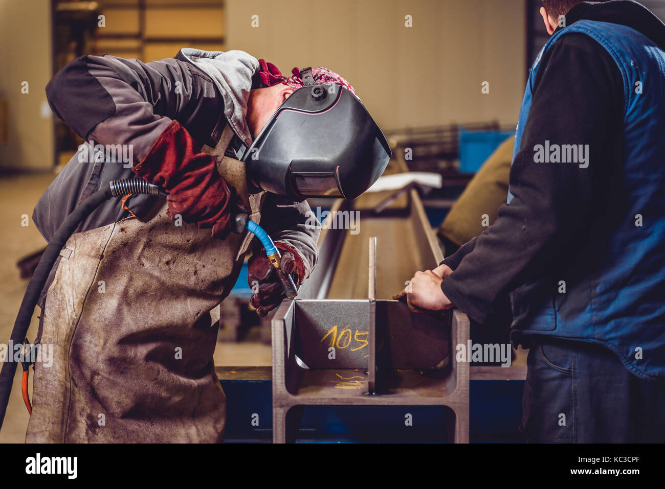 Industrial Welder With Torch preparing to welding metal profiles Stock Photo
