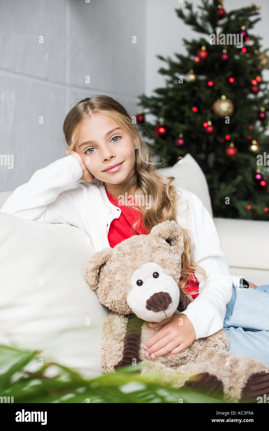 child with teddy bear at christmas tree Stock Photo - Alamy