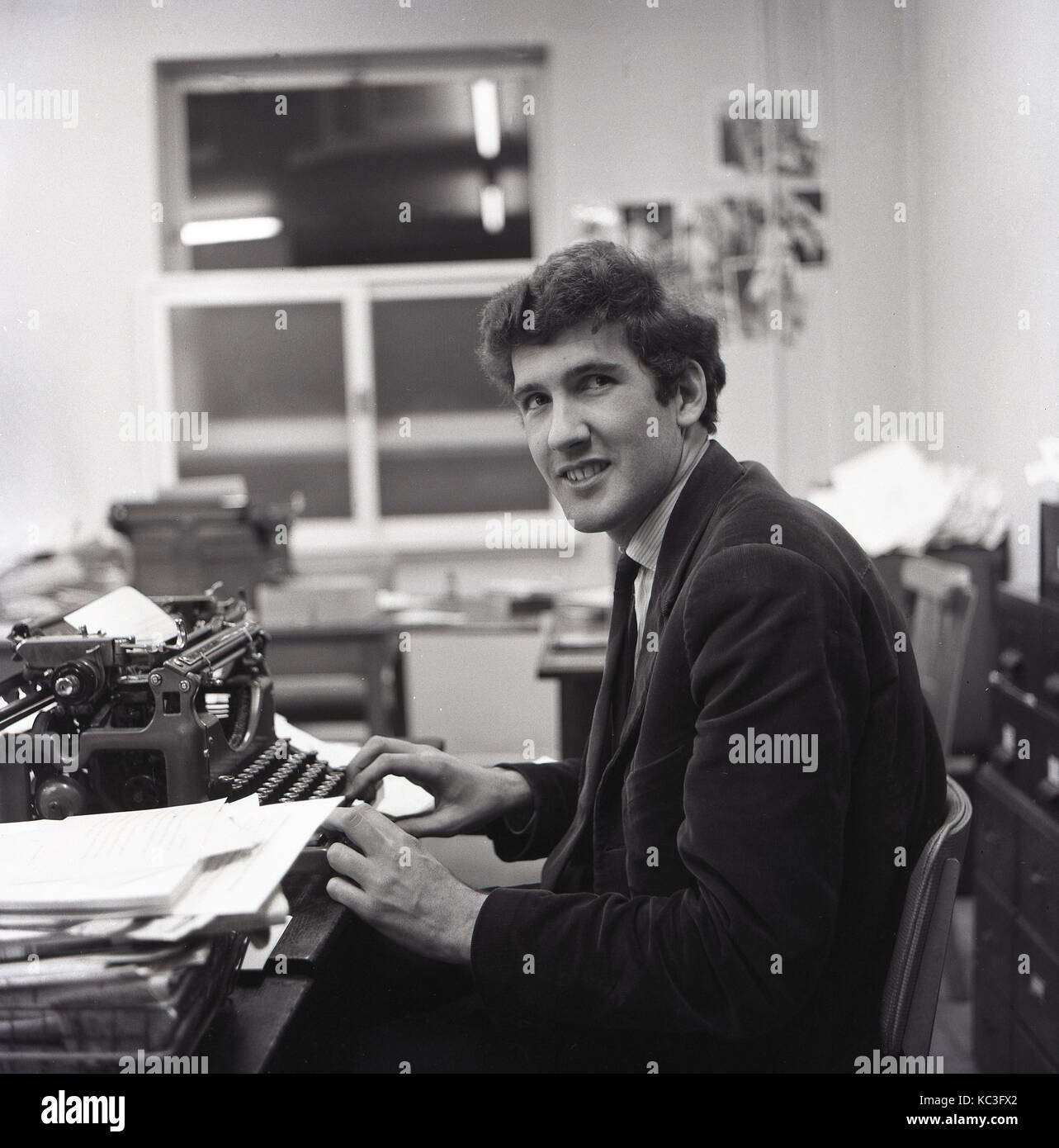 1964 Historical A Male Newspaper Reporter At His Work Desk Using Typewriter To 1964 Historical A Male Newspaper Reporter At His Work Desk Using Typewriter To