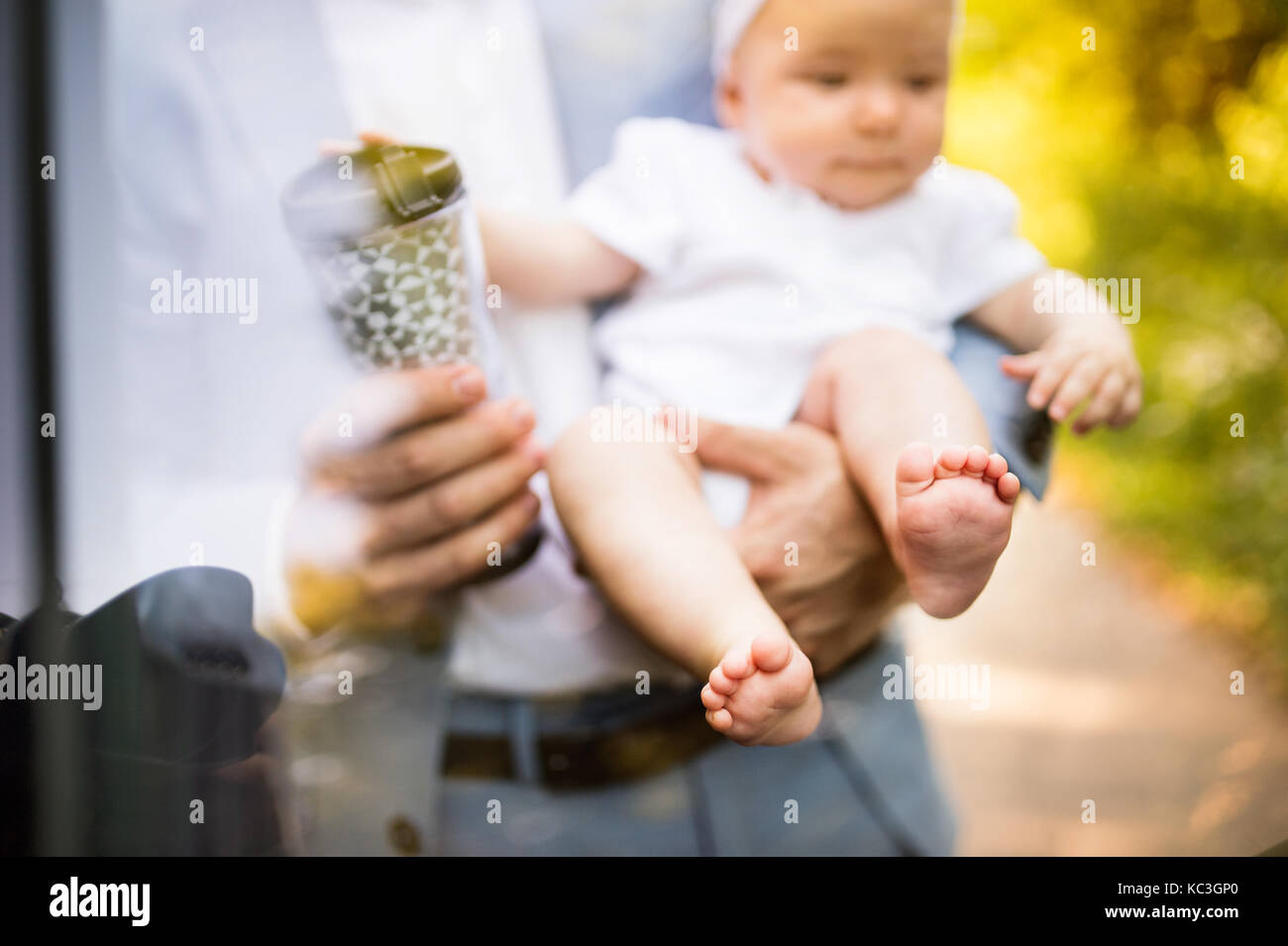 Unrecognizable man carrying his baby girl. Stock Photo