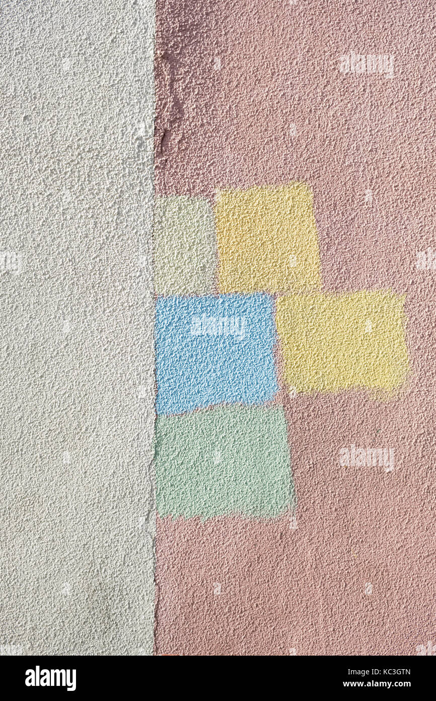 Choosing colours for a house - test patches of different colours on an exterior wall Stock Photo