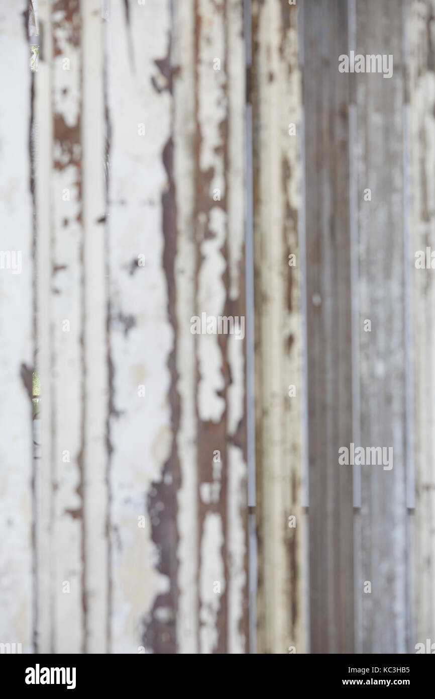 Peeling white paint from a wooden fence Stock Photo