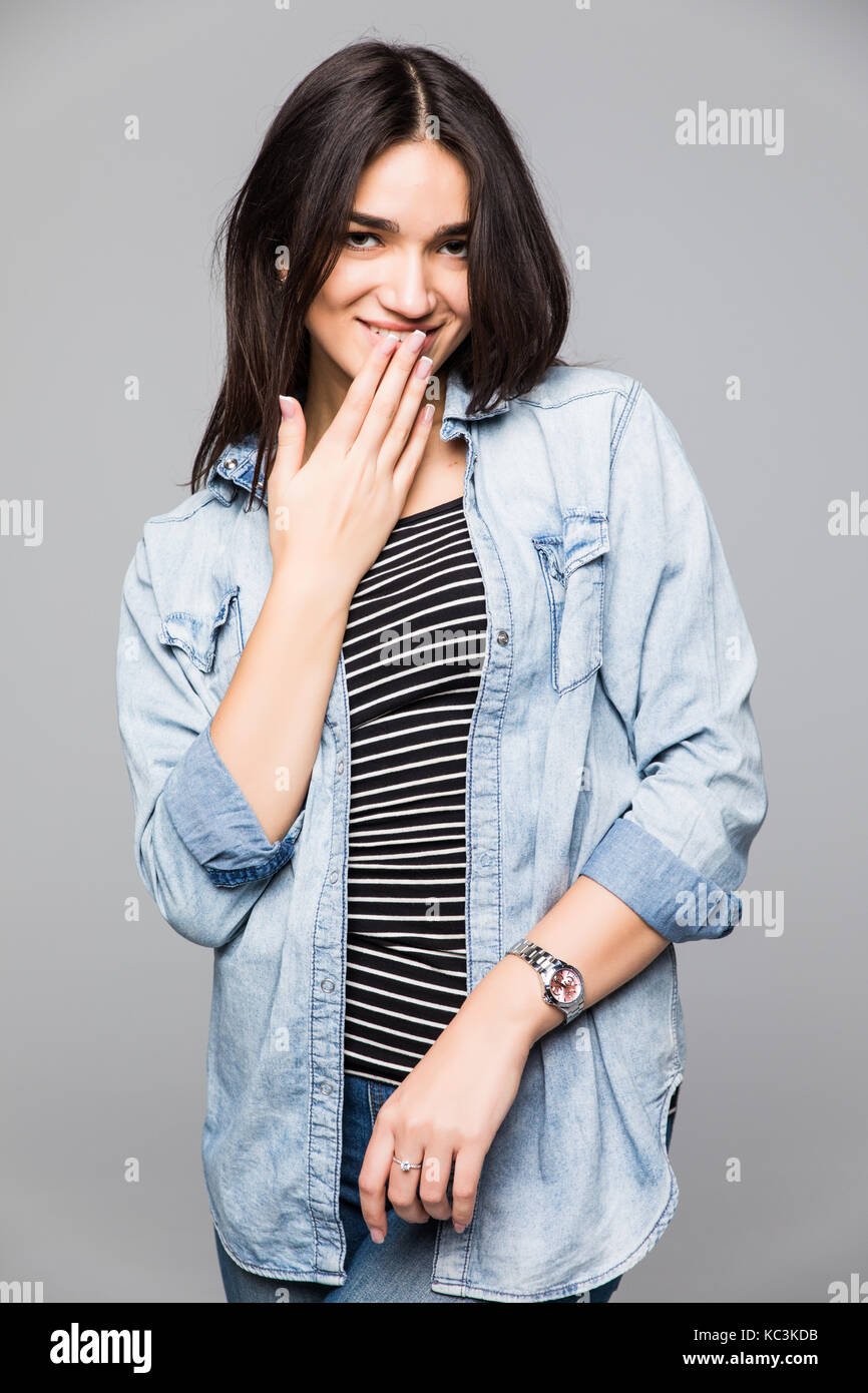 Young amazed woman covering her mouth with hand Stock Photo - Alamy