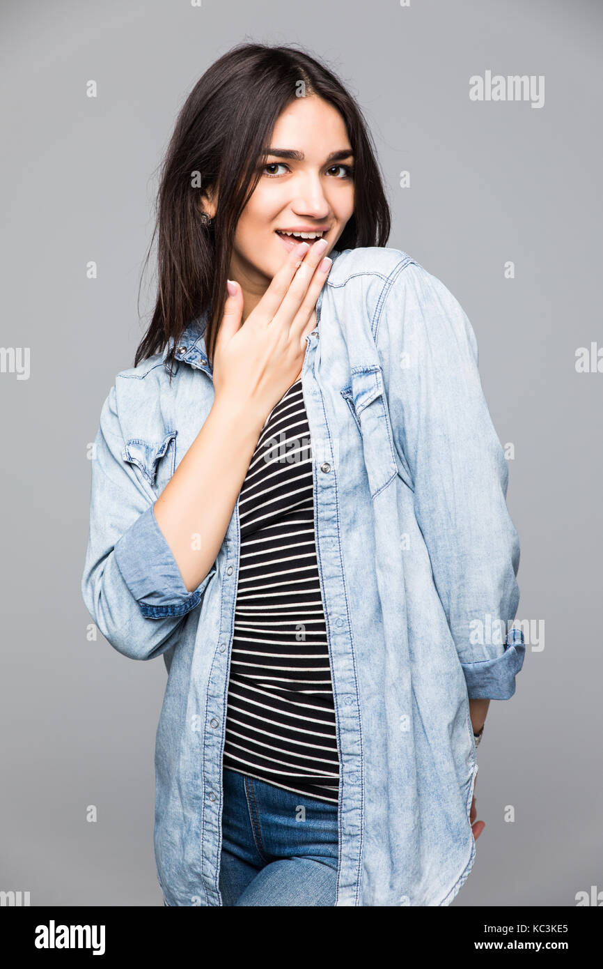 Young amazed woman covering her mouth with hand Stock Photo - Alamy