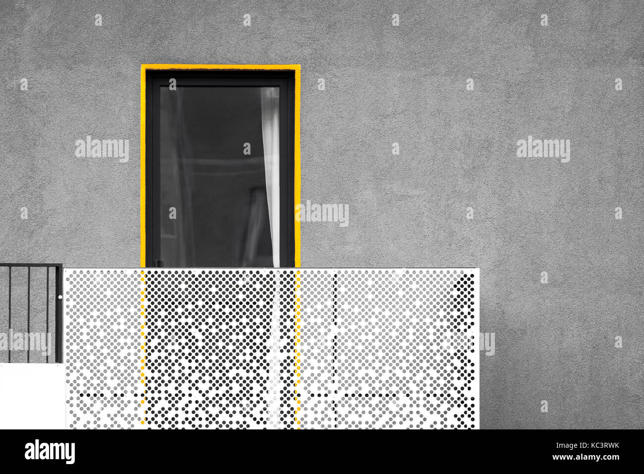 Abstract modern architecture with balcony and window. Black and white picture with yellow detail standing out Stock Photo