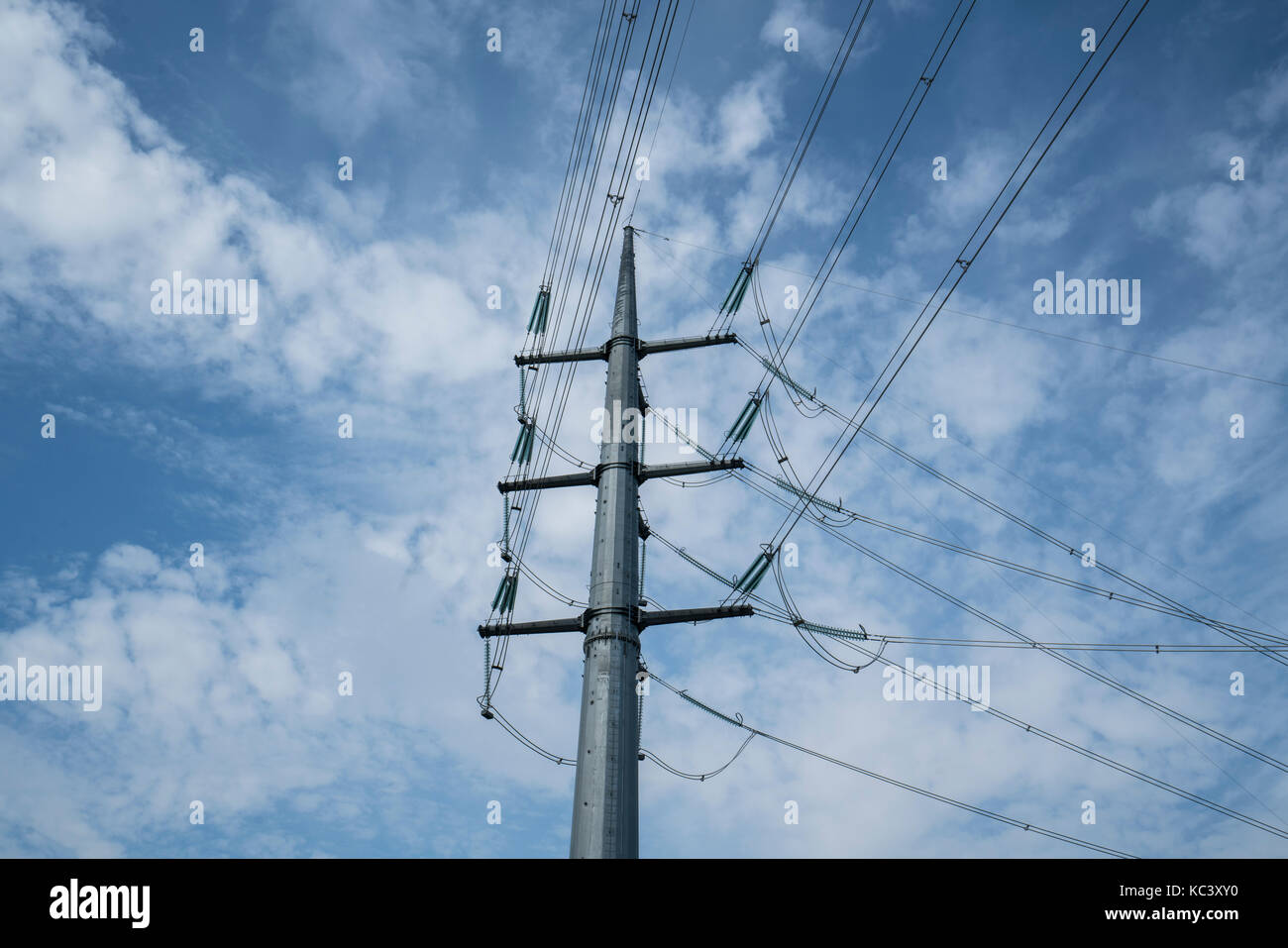 high voltage trellis with clouds in the sky in the background Stock Photo