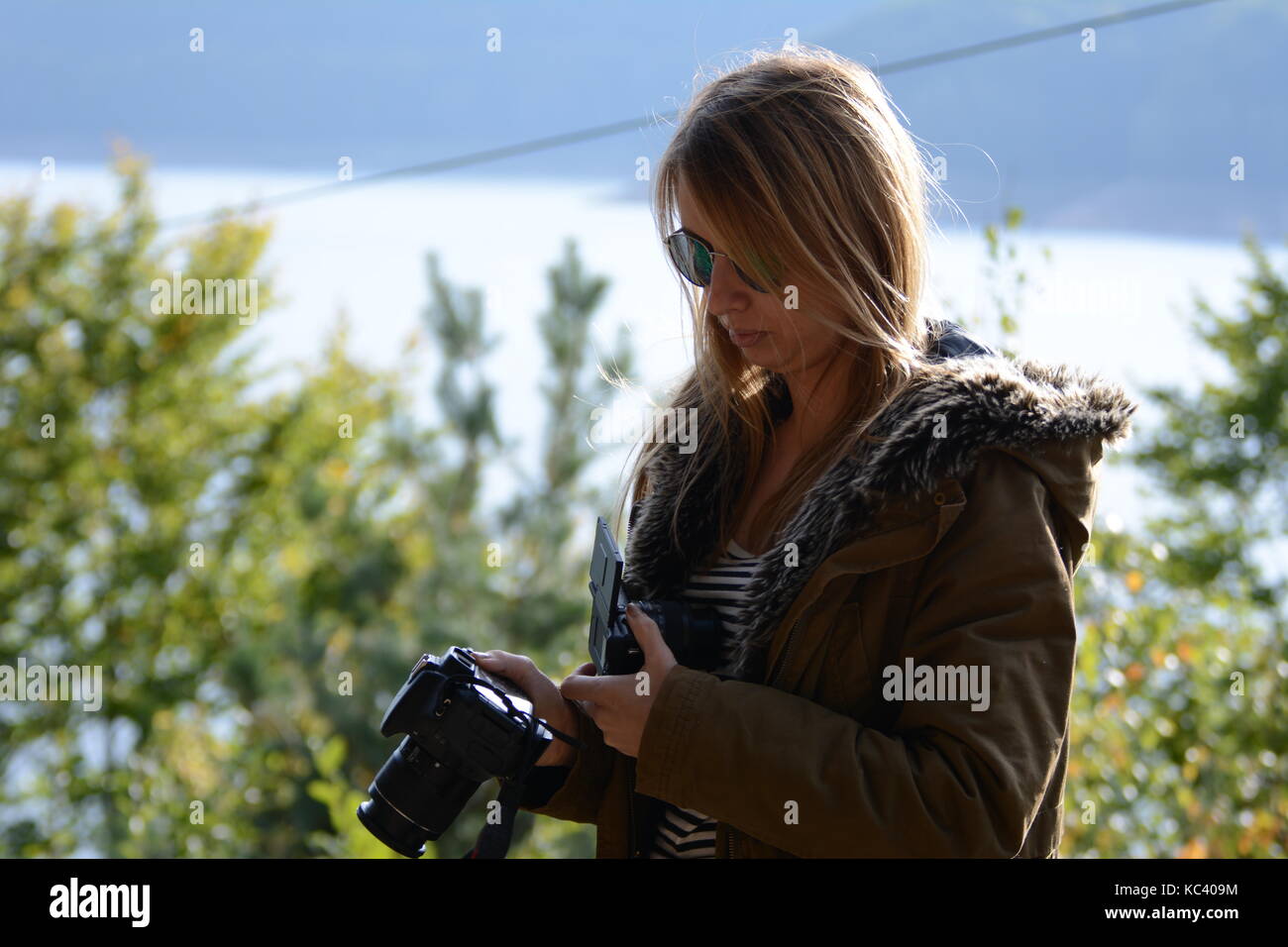 20 September 2017-Arges, Romania. Young, female blogger testing out a new Canon camera for a review Stock Photo