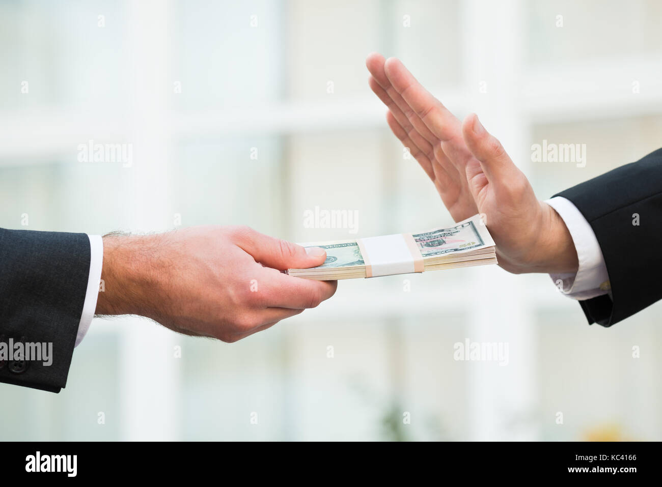 Cropped hand of businessman refusing to take bribe from partner outdoors Stock Photo