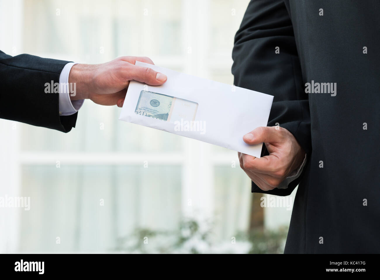 Cropped image of businessman receiving bribe from partner outdoors Stock Photo