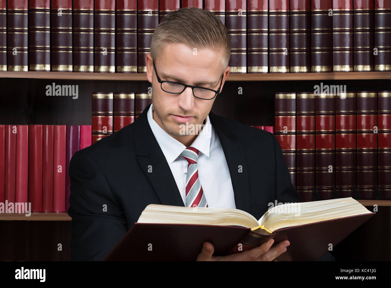 Young male lawyer reading legal book at courtroom Stock Photo Alamy