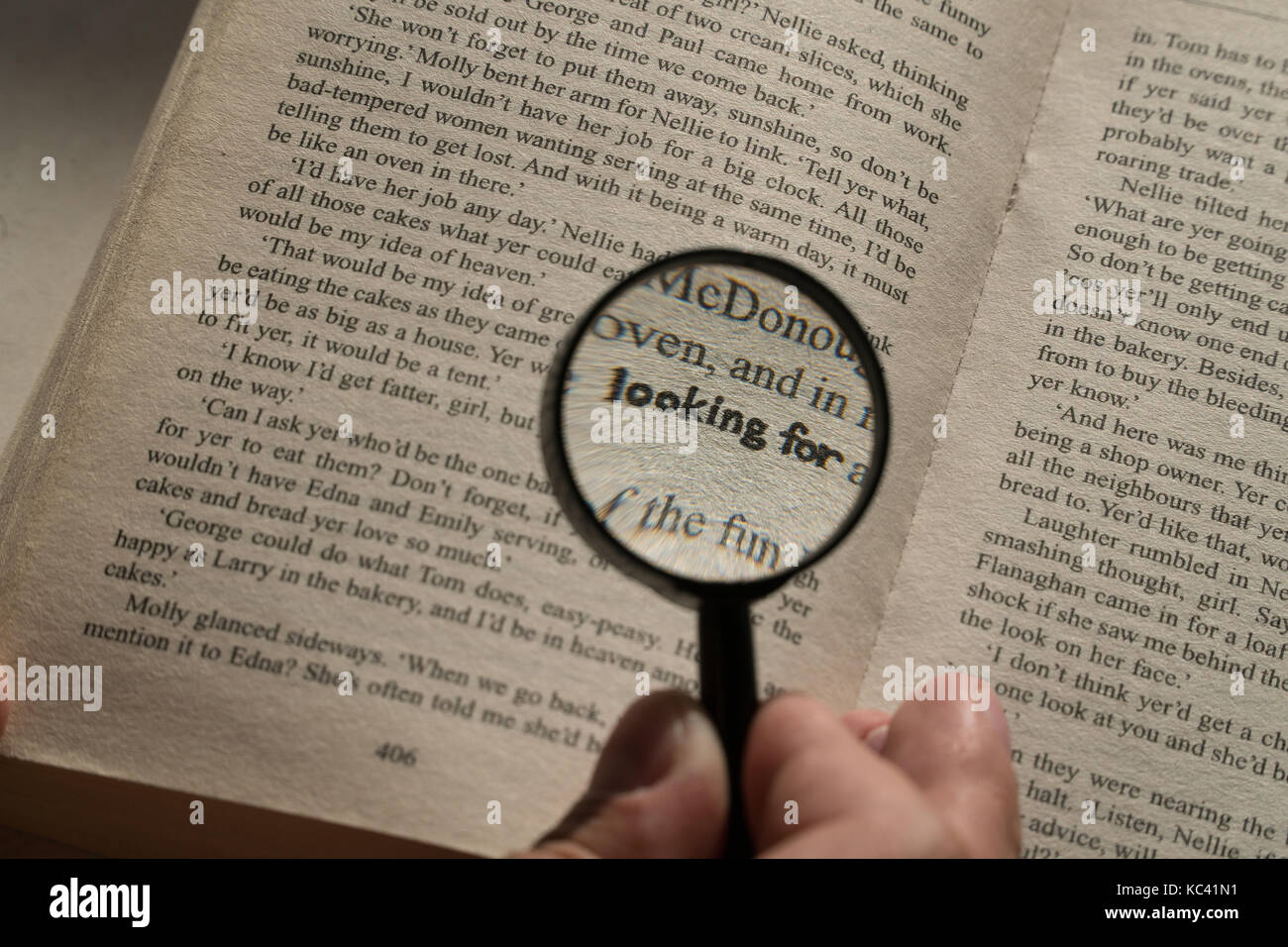 View through loupe at book. Word looking for Stock Photo Alamy