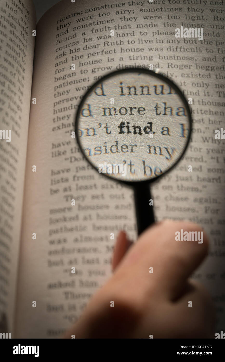 View through loupe at book. Word find Stock Photo Alamy