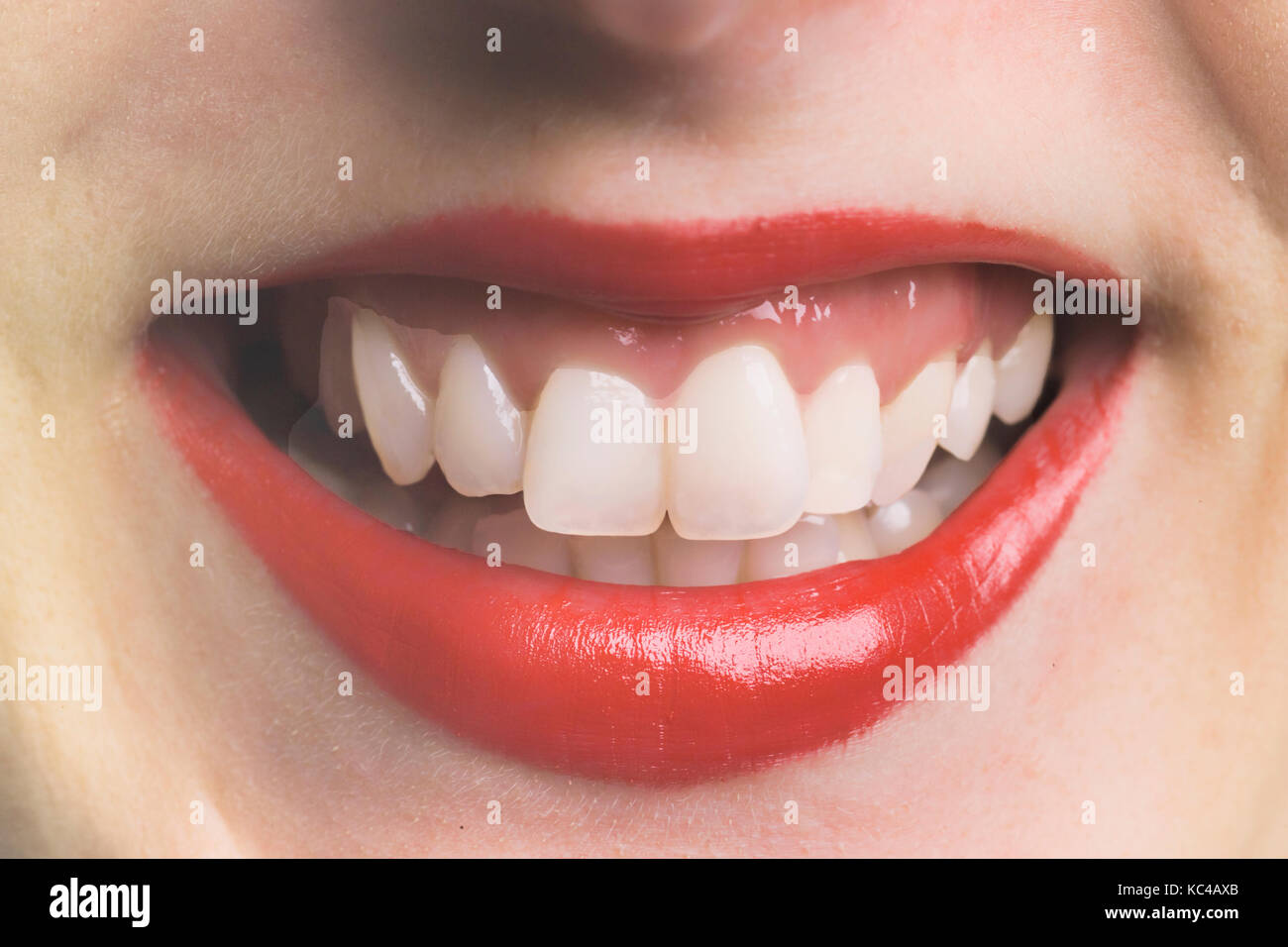 Smiling mouth of a woman using lipstick made from wax derived from wheat-straw, in an experimental environmentally-friendly process piloted at York Un Stock Photo