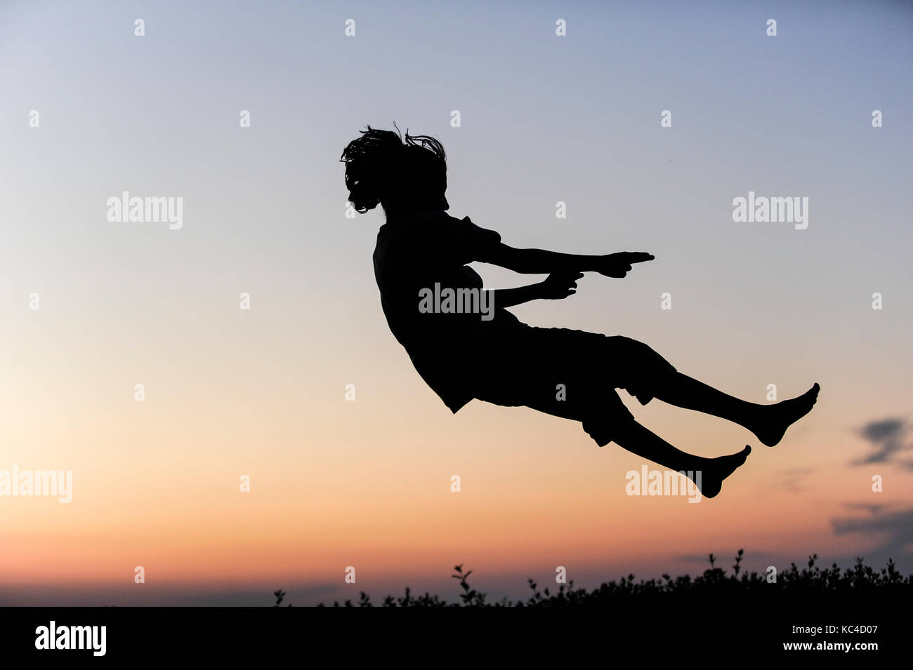 Germany, boy jumping on trampoline, Silhouette Stock Photo
