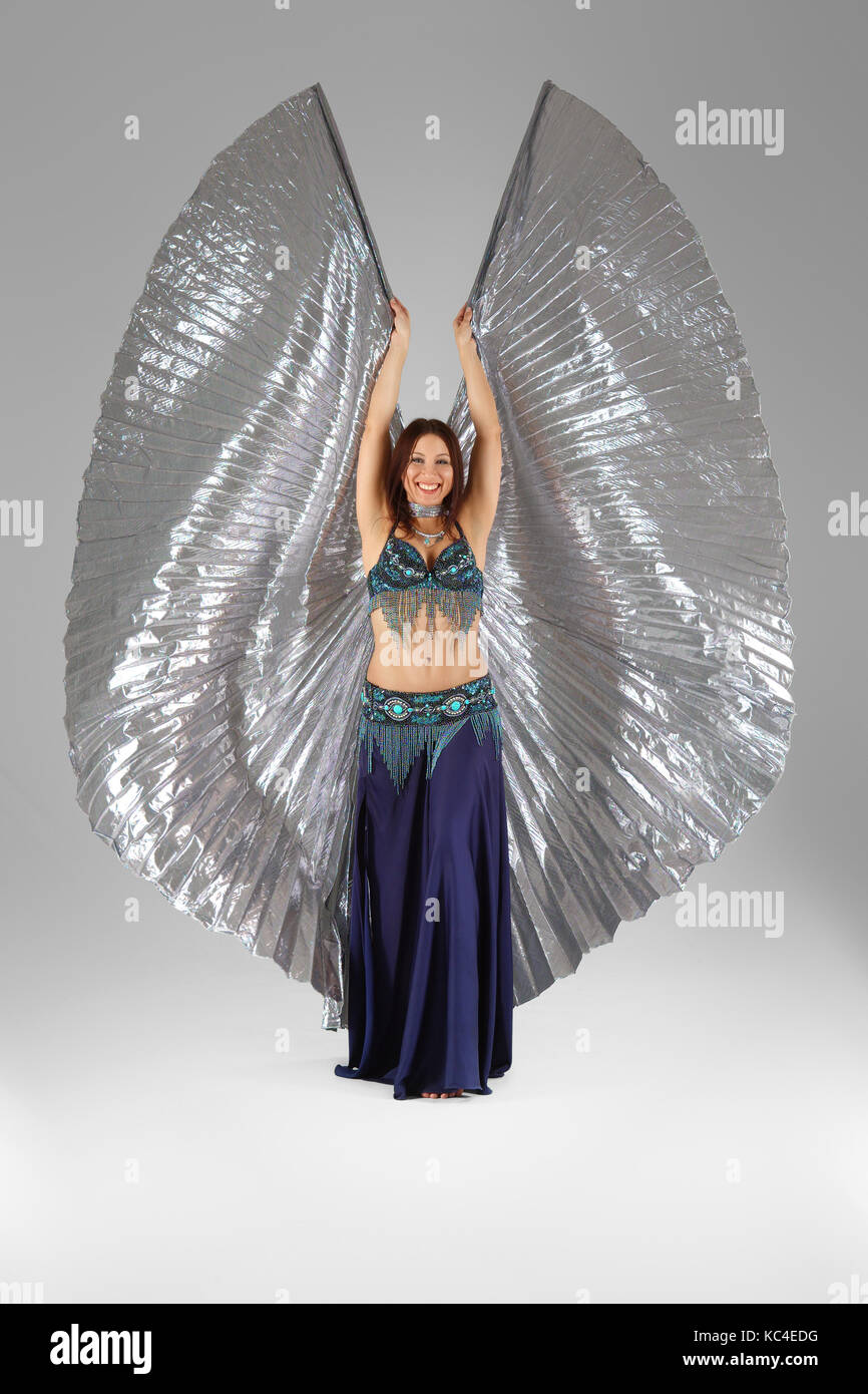 Beautiful belly dancer dancing in colorful Arabic  costume with wings Stock Photo