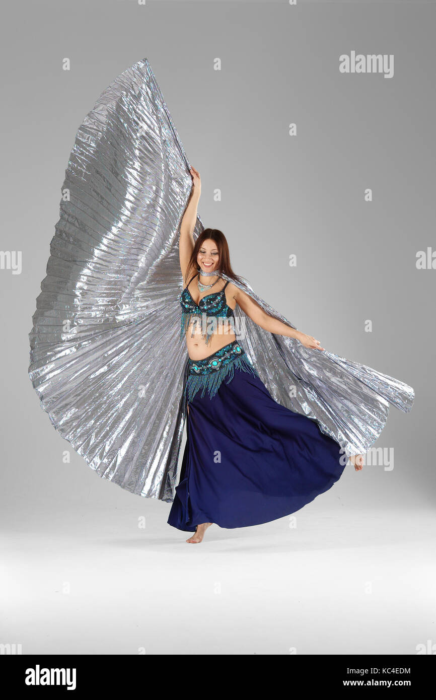 Beautiful belly dancer dancing in colorful Arabic  costume with wings Stock Photo