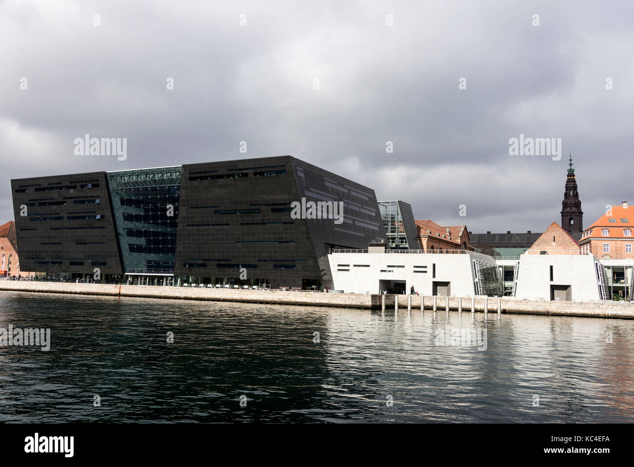 The modern diamond shaped library called the Black Diamond is a waterfront extension to the Royal Danish Library's old building on Slotsholmen in cent Stock Photo