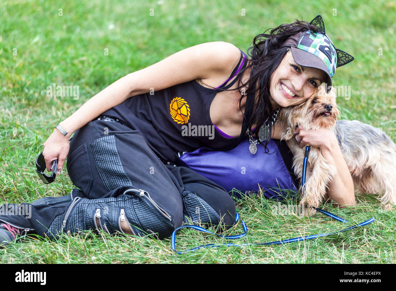 Young smiling hipster girl, Woman dog pet, woman laughing, Yorkshire Terrier, Prague girl Czech Republic Stock Photo