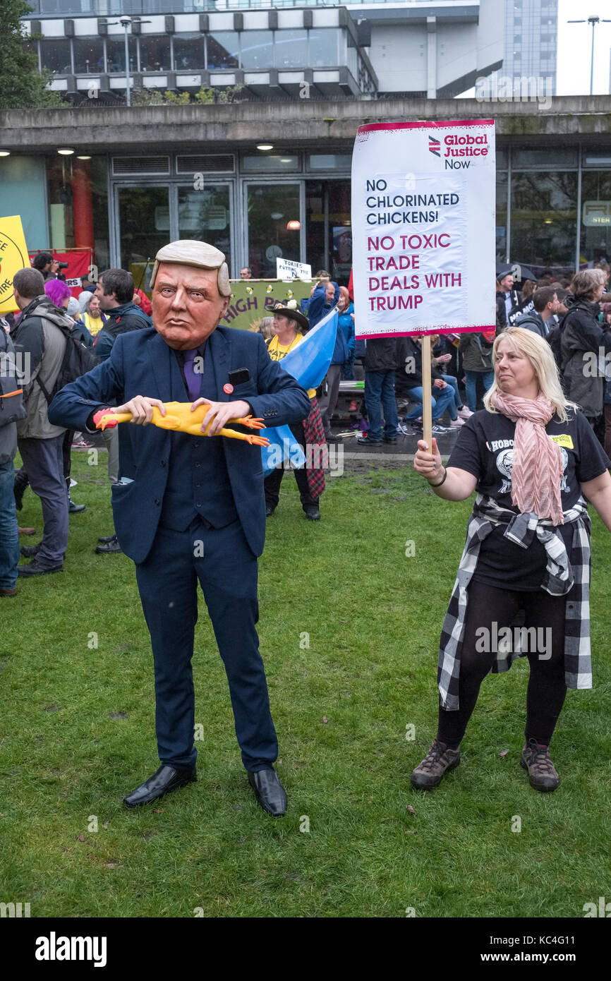 Manchester, UK. 1st Oct, 2017. A large anti austerity demonstration taking place during the Conservative Party Conference in the city centre. A man in a Donald Trump mask holds a rubber chicken. Credit: Alex Ramsay/Alamy Live News Stock Photo