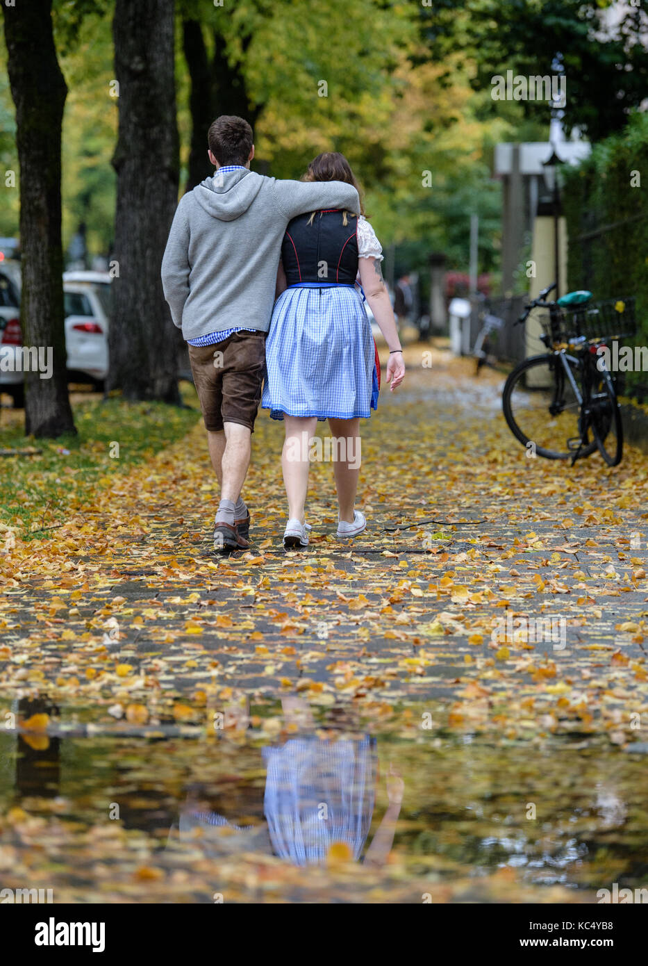 Visitors walk to the Oktoberfest fun fair grounds in the rain in Munich, Germany, 03 October 2017. After 18 days, the 184th Oktoberfest ends on 03 October 2017. Photo: Matthias Balk/dpa Stock Photo