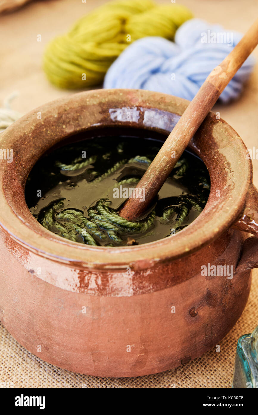 closeup of an earthenware pot where some skeins of wool are being dyed by the traditional process Stock Photo