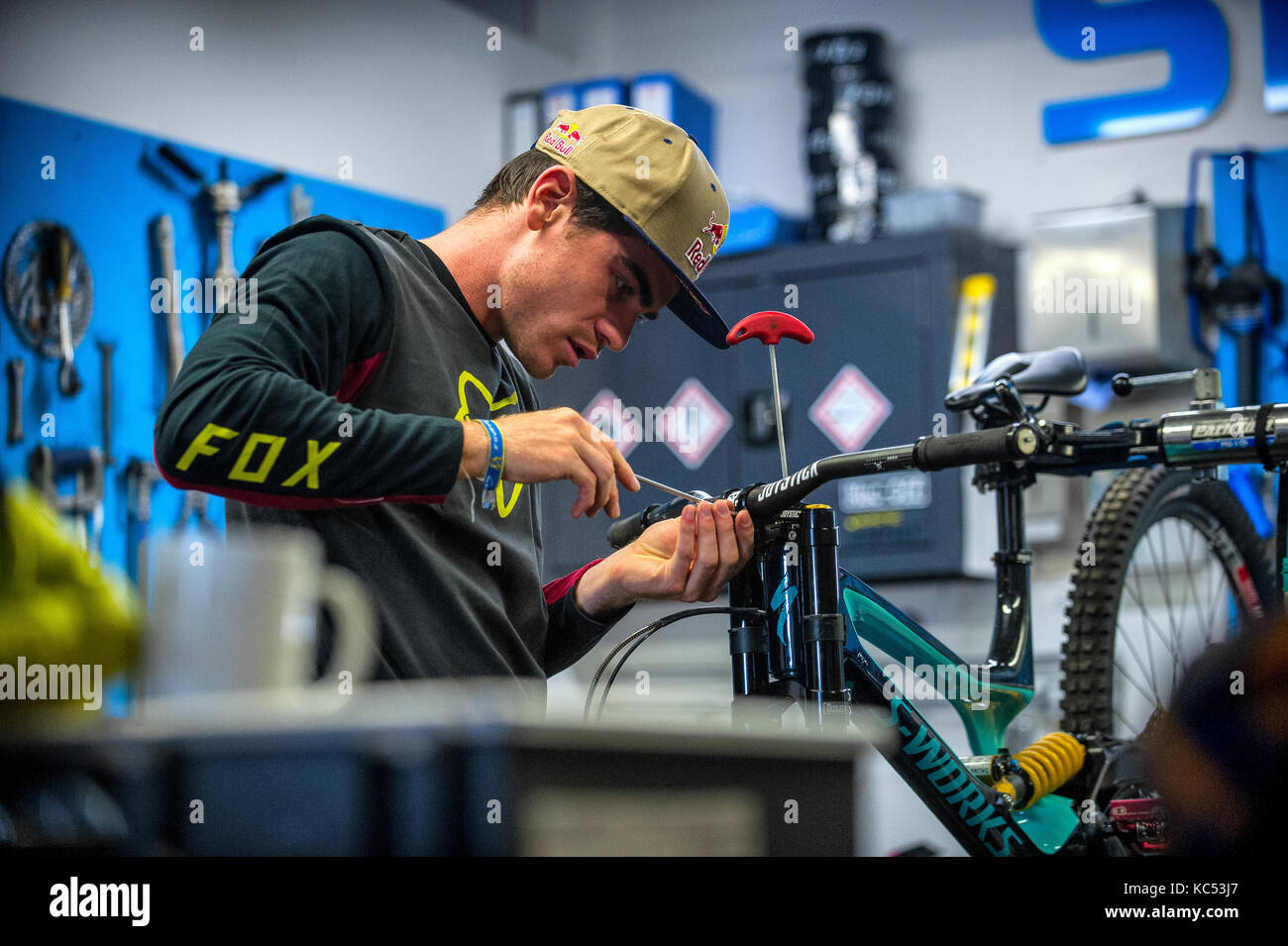 Professional downhill mountain biker Loïc Bruni. 2015 and 2017 UCI downhill mountain bike World Champion. Pictured in a workshop building his bike. Stock Photo