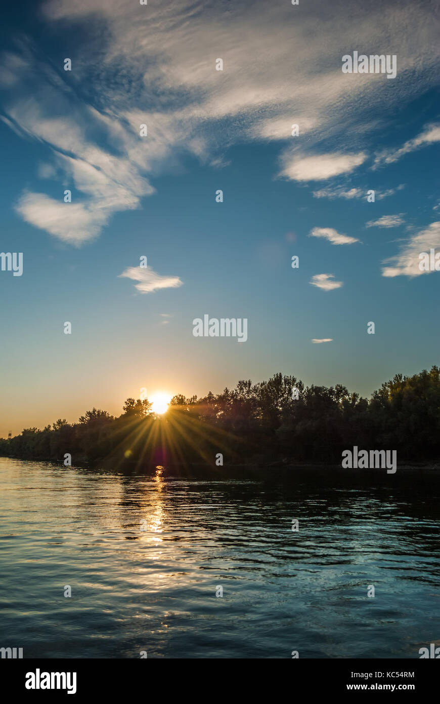 Beautiful sunset on the river, with blue sky and river Stock Photo - Alamy