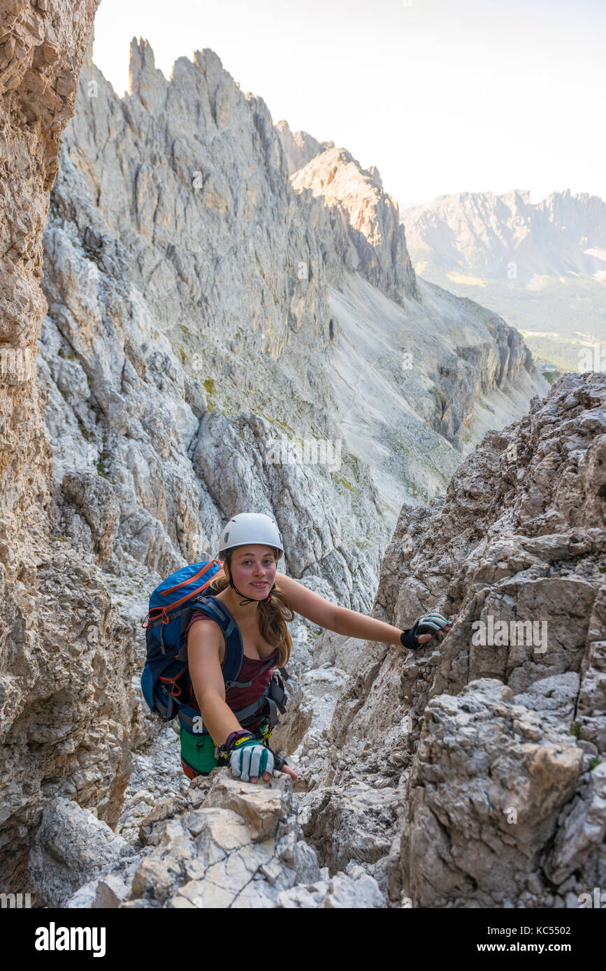 Hiker climbs the Santner via ferrata, Rosengarten Group, Dolomites, South Tyrol, Trentino-Alto Adige, Italy Stock Photo
