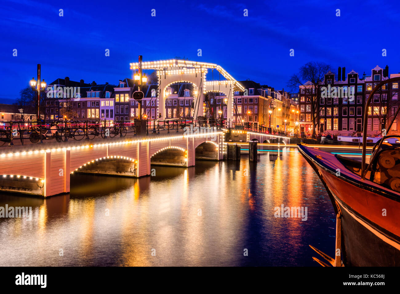 Skinny Bridge and Amstel River in Amsterdam Netherlands at Dusk Stock Photo