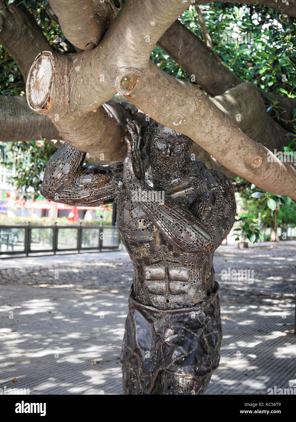Metal statue of Atlas lifting Gomero de la Recoleta tree, Recoleta, Buenos Aires, Argentina Stock Photo