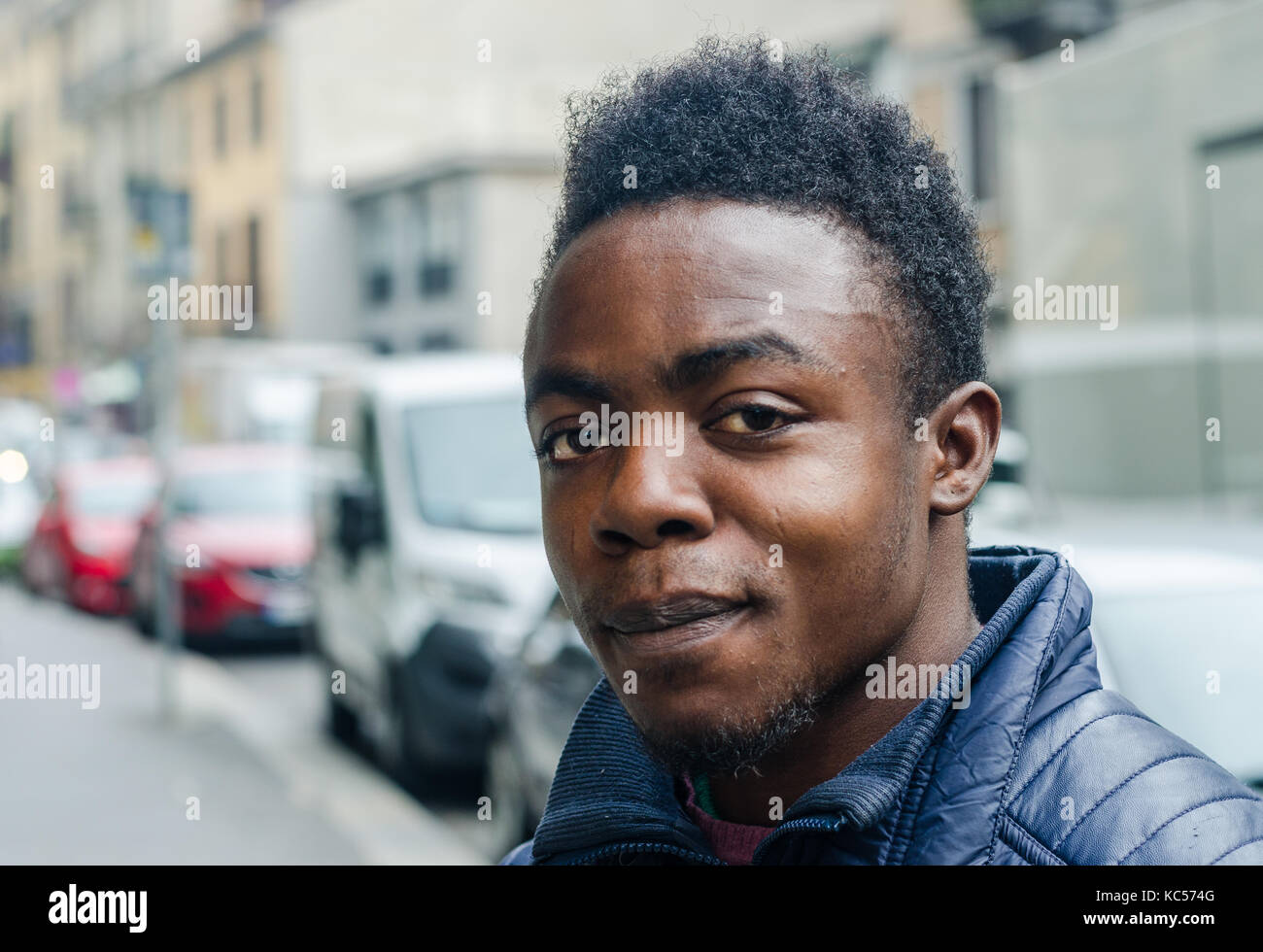 A Nigerian refugee poses for a photo in Milan, Italy. His  nickname is 'Elvis'. Europe is undergroing a refugee crisis. Stock Photo
