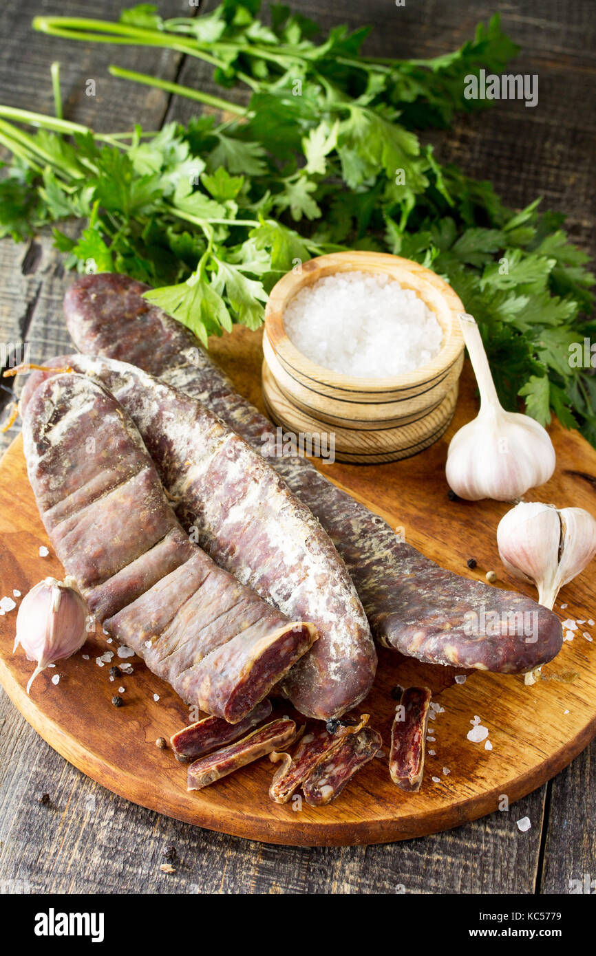 Beef jerky smoked sausage sudzhuk with spices and garlic is served on a