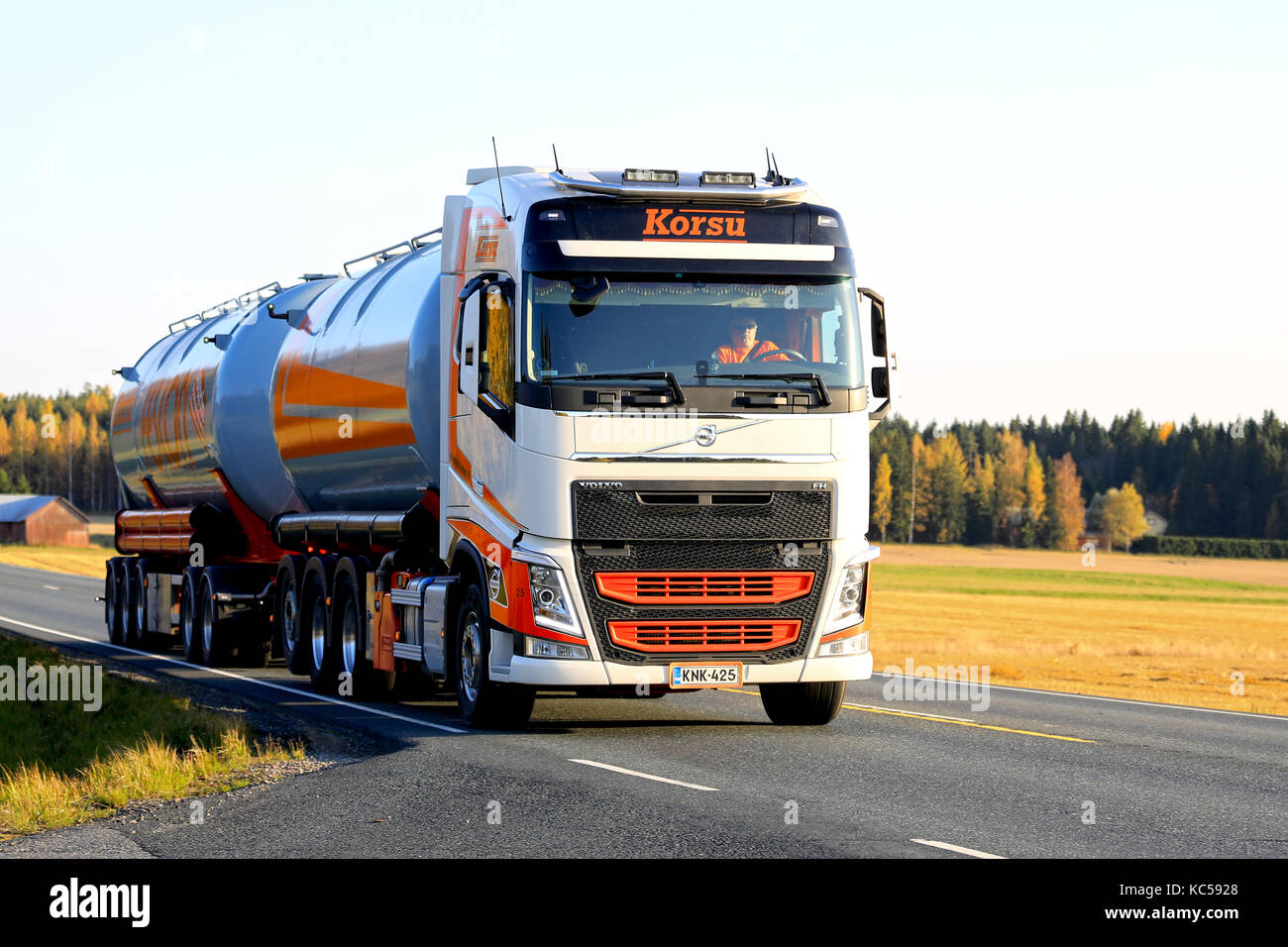 HUMPPILA, FINLAND - SEPTEMBER 29, 2017: Orange and White Volvo FH tank truck of Korsu Oy moves along autumnal highway at sunset time in South of Finla Stock Photo
