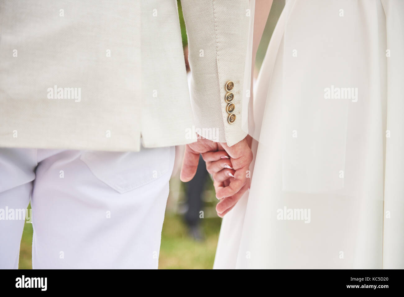 Wedding day background. Happy couple holding hands together as forever love Stock Photo