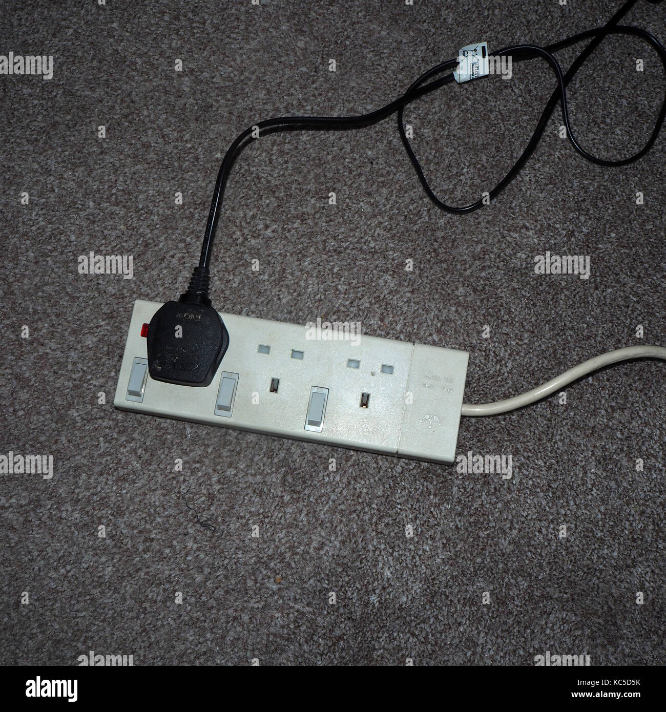 White plug board Extension Lead on office floor Stock Photo Alamy