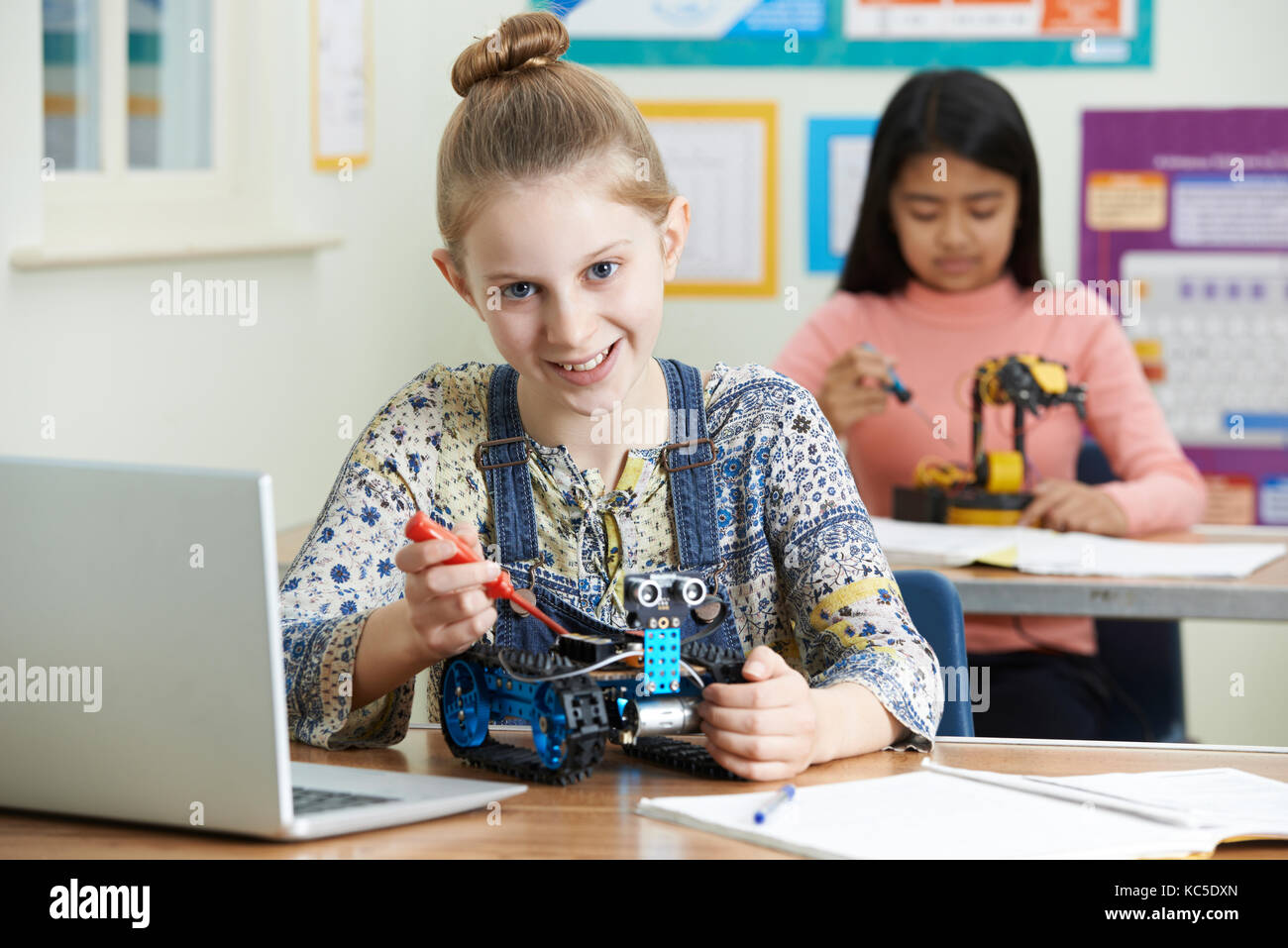 Portrait Of Female Pupil In Science Lesson Studying Robotics Stock Photo