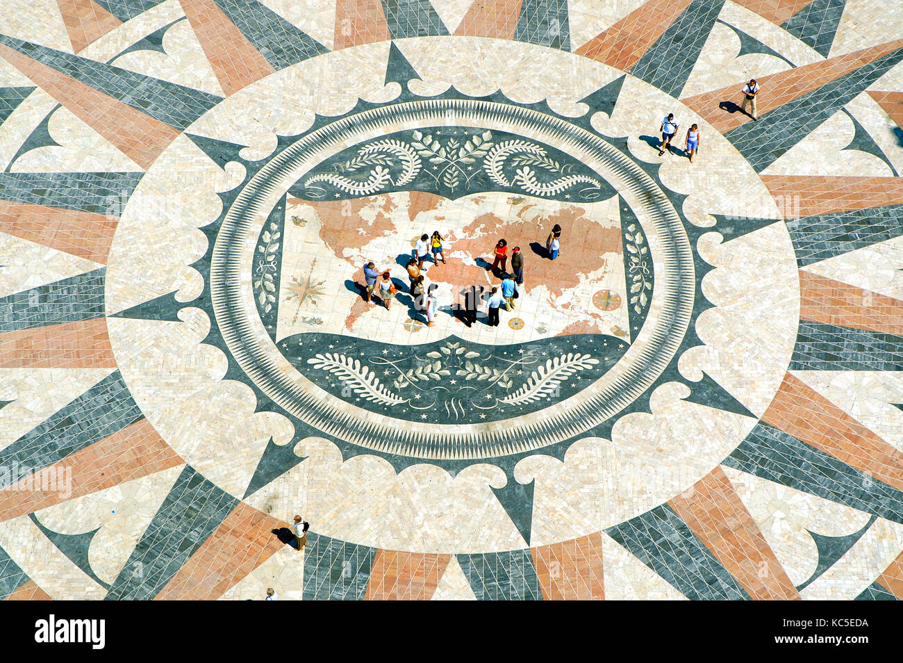 A group of tourists stand in the centre of the compass pavement in front of the Monument to the Discoveries, Lisbon, Portugal Stock Photo