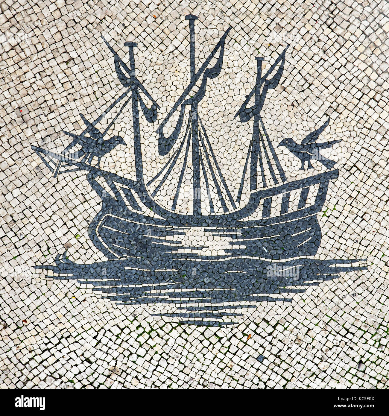 Stone pavement (calçada à portuguesa) depicting a caravel. Lisbon, Portugal Stock Photo