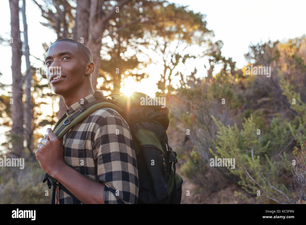 Young African man hiking alone in the wilderness at dusk Stock Photo ...