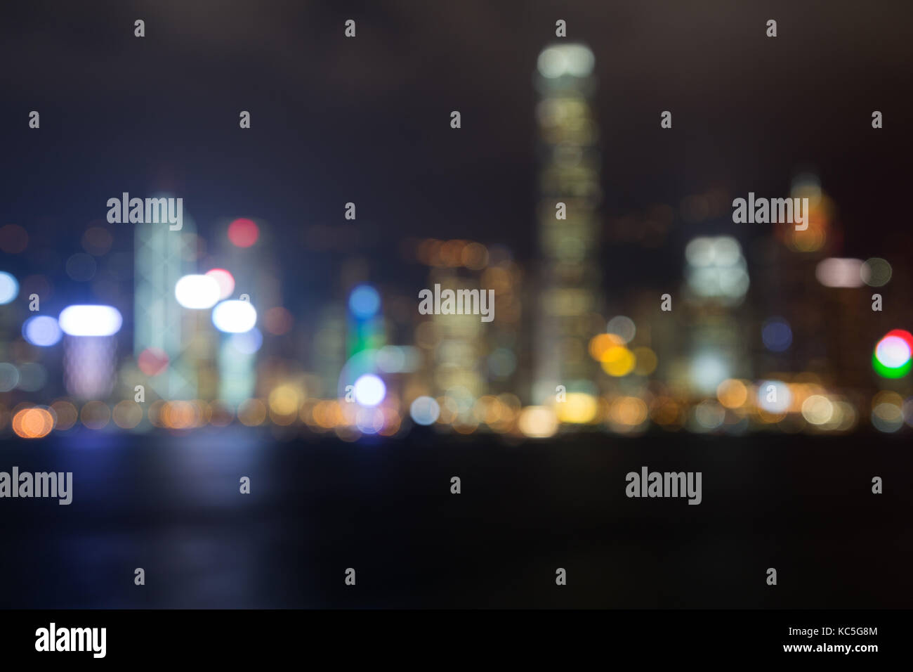 Blurred bokeh city lights of Hong Kong Island's skyline with lit modern skyscrapers at night in Hong Kong, China. Stock Photo