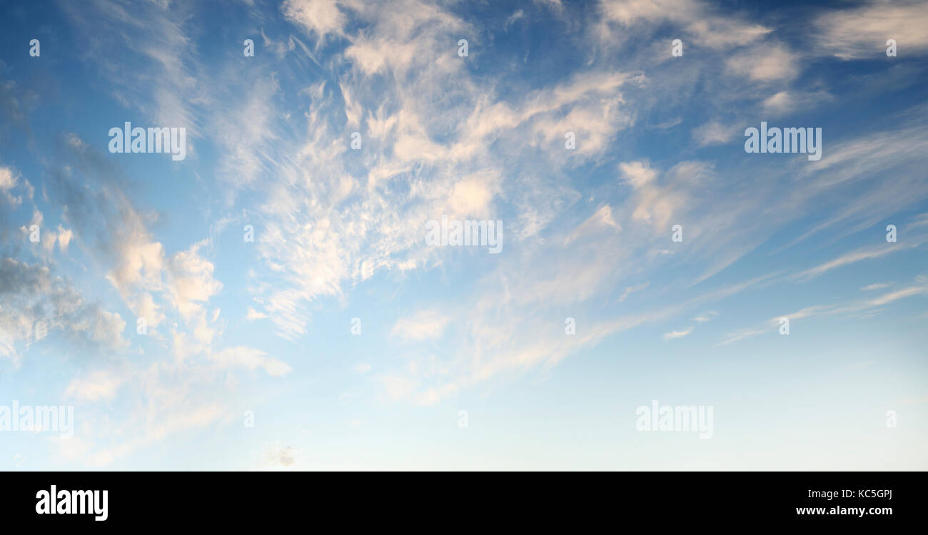 Fluffy clouds in a blue sky Stock Photo - Alamy