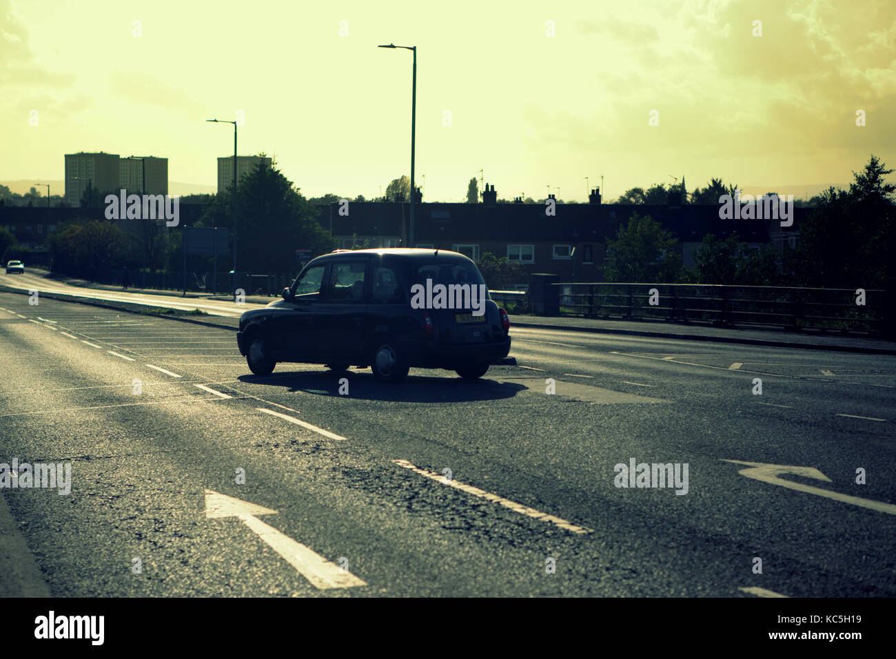 black taxi back lit open road with markings arrows nobody copyspace Stock Photo