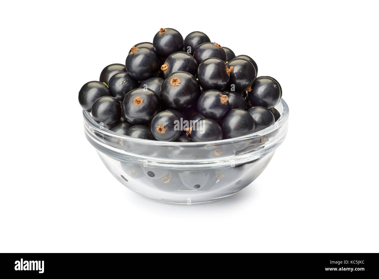 Bowl with black currant berries on white Stock Photo
