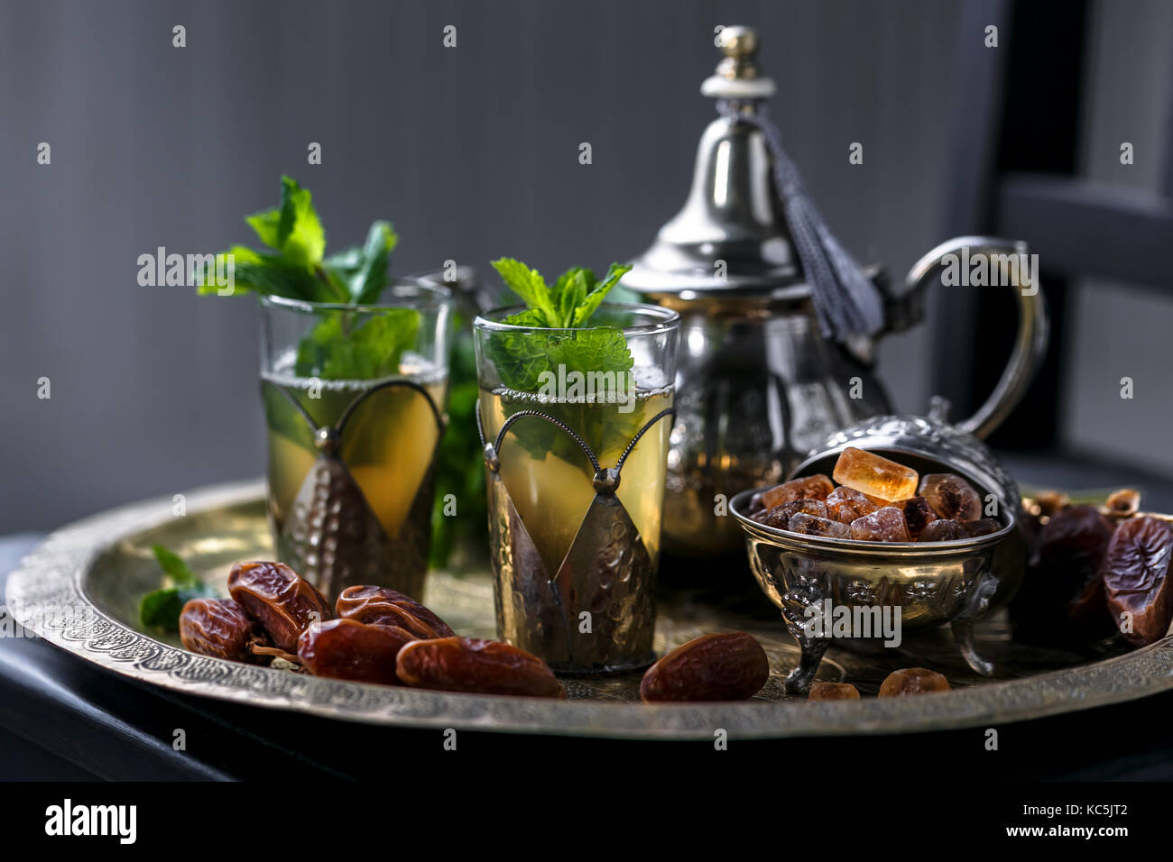 Moroccan tea with mint in traditional glasses, teapot and sugar Stock