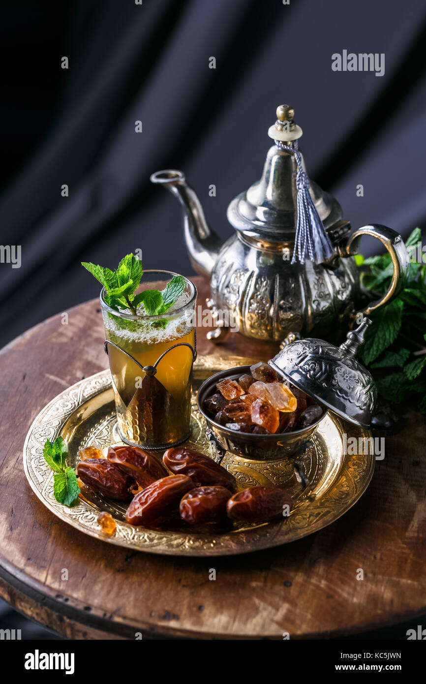 Moroccan tea with mint and sugar in a glass on a dark background Stock ...