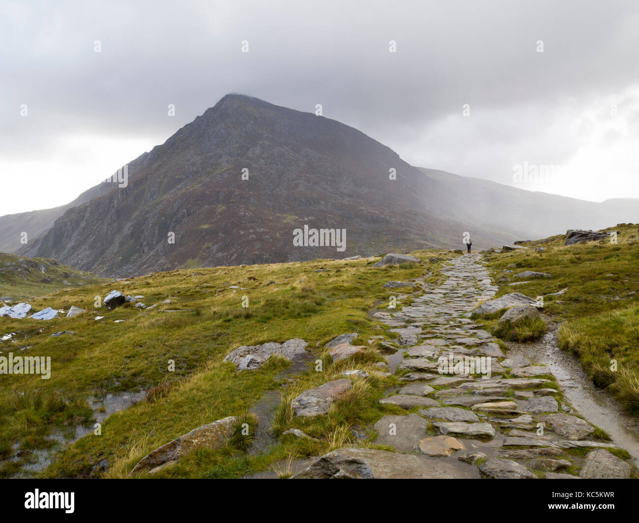 Snowdonia National Park hikers on rock path in mountains to Cwm Idwal Stock Photo