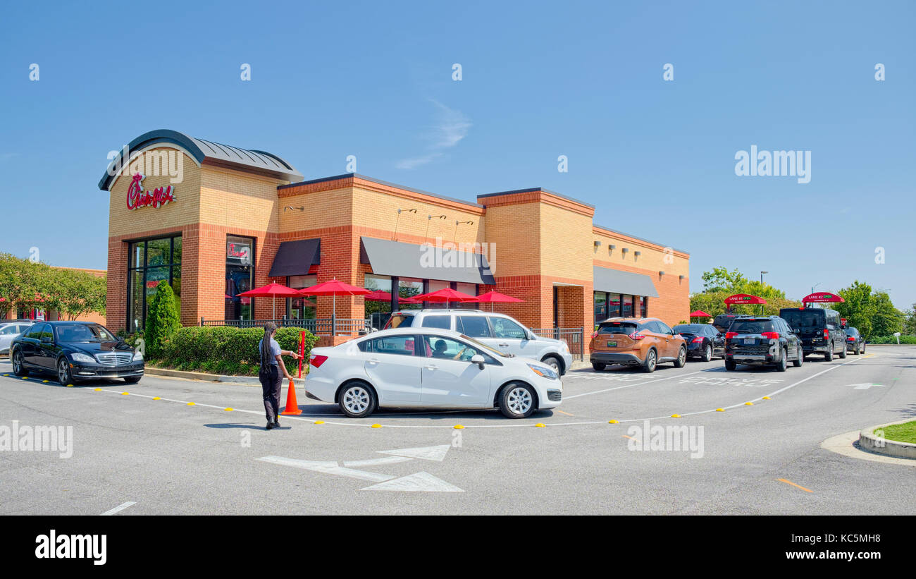 Chick-fil-A fast food restaurant double drive through lanes on a busy lunch hour.  Montgomery, Alabama USA Stock Photo