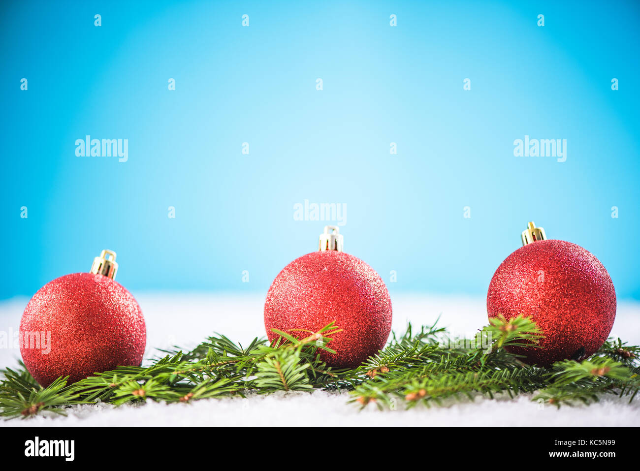 Christmas red balls and green fir on snow Stock Photo - Alamy
