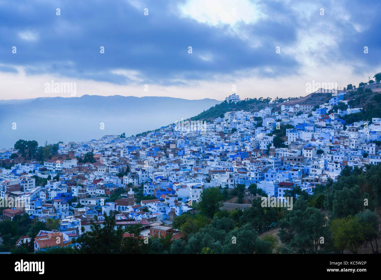Panoramic view of blue city of Chefchaouen at rising, Morocco. Clouds over summits Stock Photo