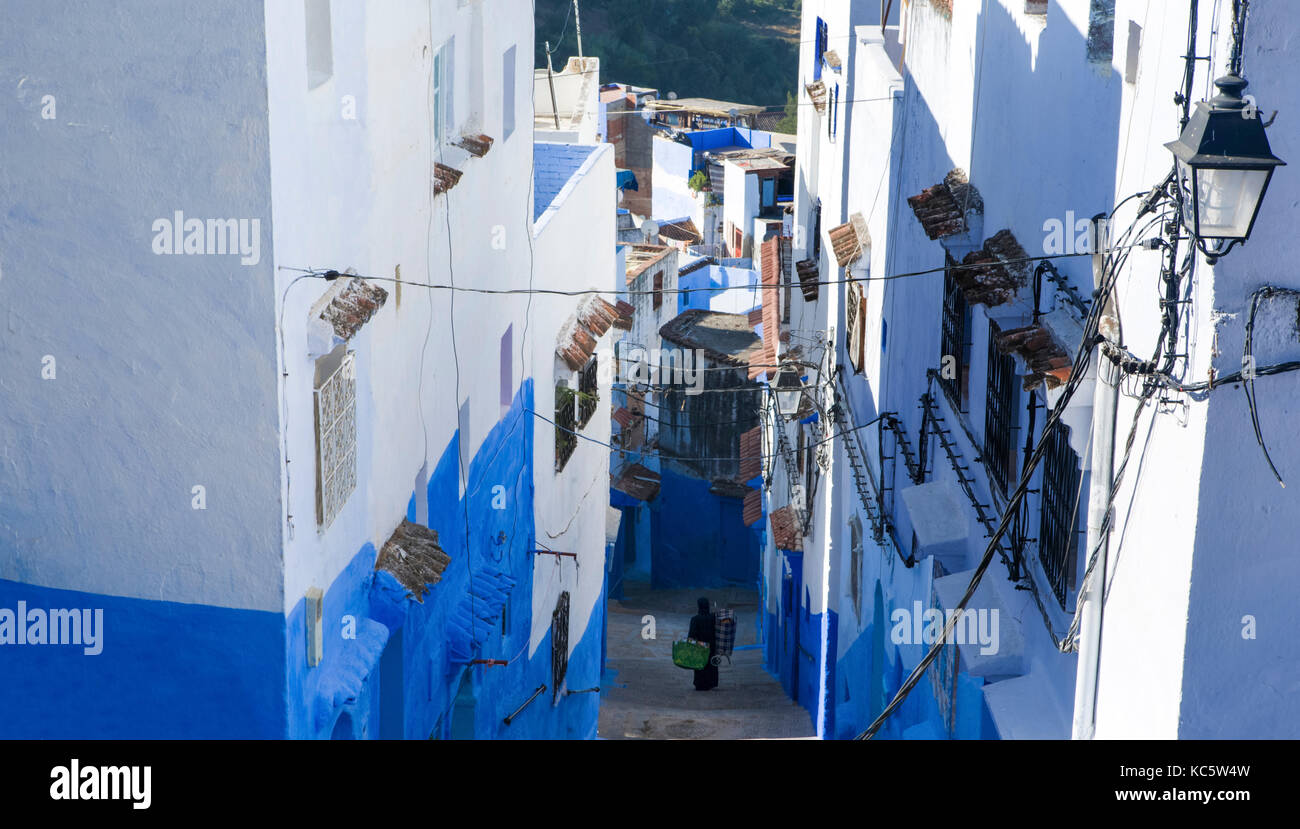 Unrecognizable natives on traditional moroccan architectural details in Chefchaouen, Morocco, Africa Stock Photo